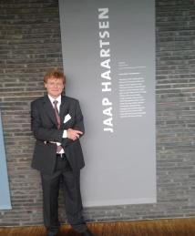 Jaap C. Haartsen standing infront of disply at  European Inventor Awards