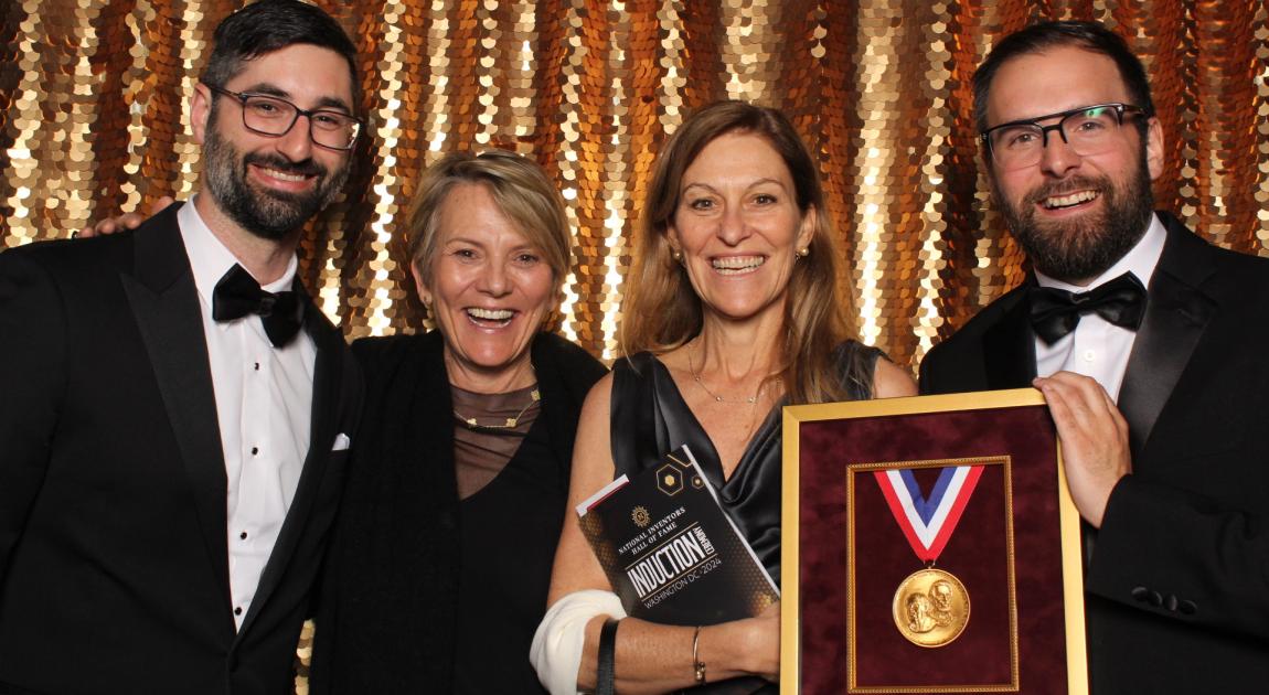 Nicole Beaudoin, Nathalie Bissonnette and others pose in a photo booth with a sparkling gold backdrop